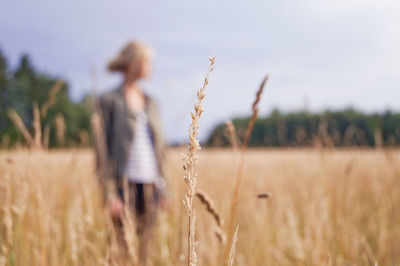 Woman standing on agricultural field
