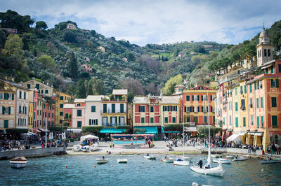 Boats in water against buildings