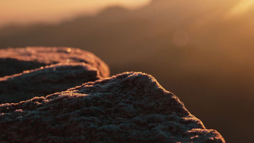 Close-up of rock against sky during sunset