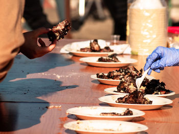 Close-up of hand holding food on table