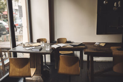 Empty chairs with diary on table in restaurant