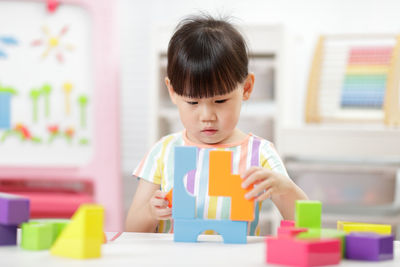 Boy with toy on table