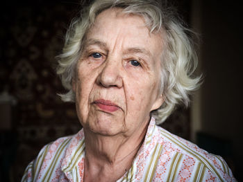 Close-up portrait of senior woman at home
