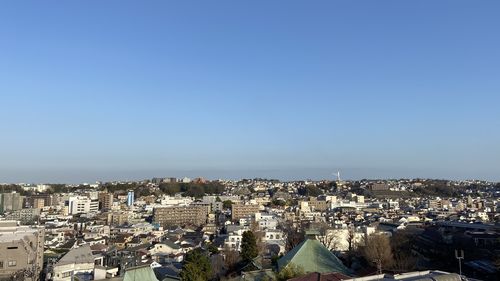 High angle shot of townscape against blue sky