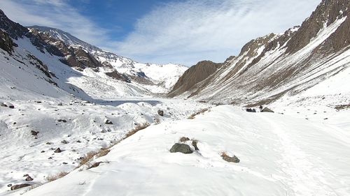 Scenic view of snow covered mountains against sky