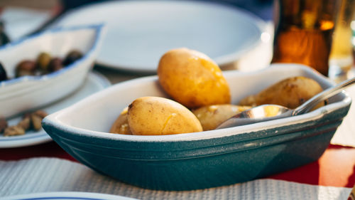 Potatoes in container on table