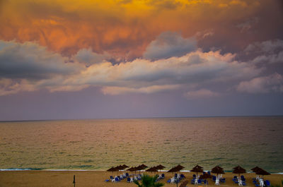 People on beach against sky