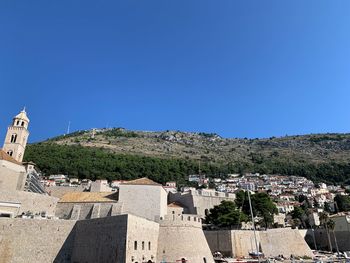 Townscape against clear blue sky