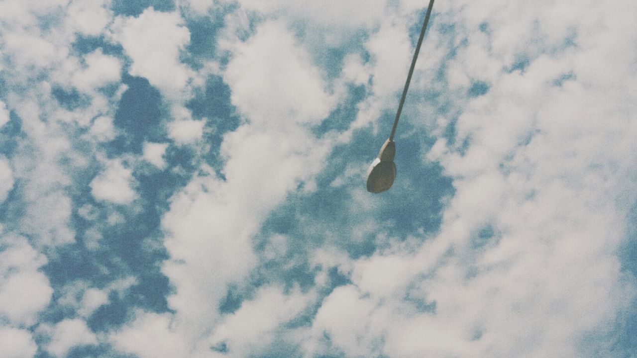 low angle view, sky, cloud - sky, cloudy, nature, tranquility, beauty in nature, cloud, day, transportation, blue, outdoors, flying, mid-air, no people, scenics, tranquil scene, cable, weather, white color