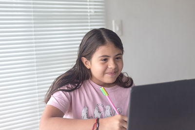 Portrait of smiling girl using mobile phone