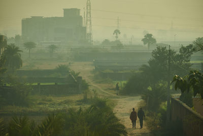 Panoramic view of a field with smog