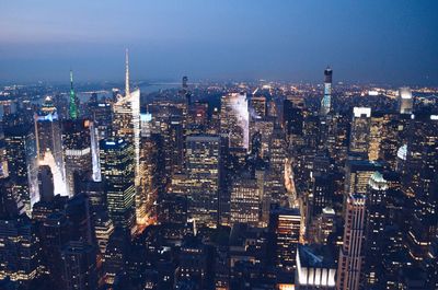 High angle view of illuminated cityscape against sky at dusk