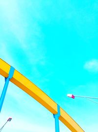 Low angle view of road sign against blue sky