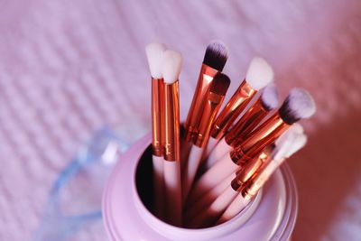 Close-up of make-up brushes in container