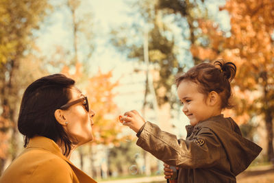 Portrait of mother and daughter outdoors