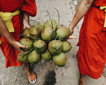 High angle view of people holding fruit