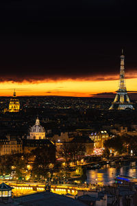 Illuminated cityscape against sky at night