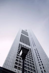 Low angle view of street light against one raffles place