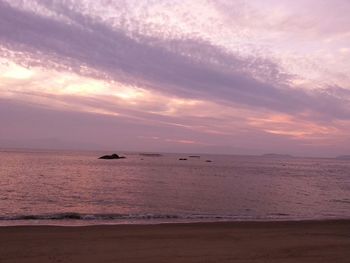 Scenic view of sea against cloudy sky