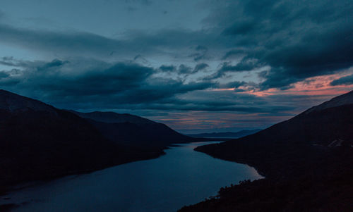 Silhouette of mountain against cloudy sky