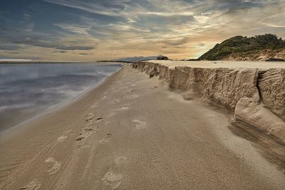 Scenic view of beach against sky during sunset