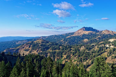 Scenic view of mountains against blue sky