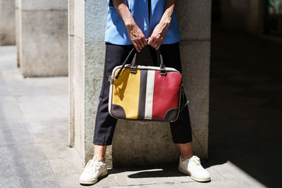 Low section of woman standing on street