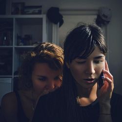 Close-up of young woman using smart phone