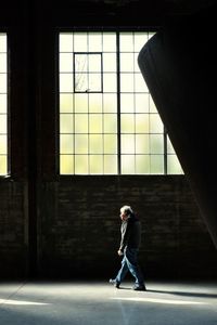 Man standing in corridor of building