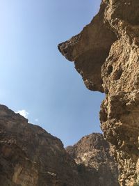 Low angle view of rock formation against clear sky