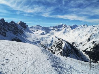 Scenic view of snow covered mountains against sky