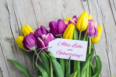 High angle view of bouquet with text on table