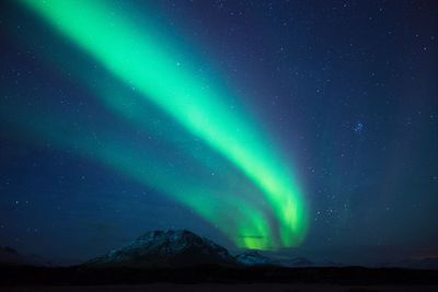 Scenic view of mountains against sky at night