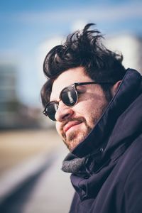 Portrait of man wearing sunglasses against sky