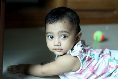 Portrait of cute baby girl relaxing at home