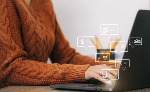Midsection of woman using laptop