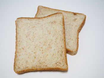 Close-up of cake on plate against white background