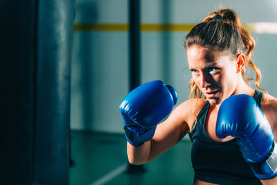 Boxer hitting on punching bag at gym