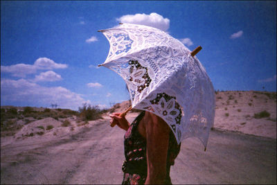 Side view of person on land against sky