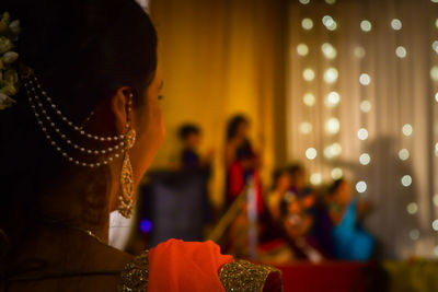 Woman looking at illuminated light