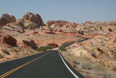 Road in desert against clear sky