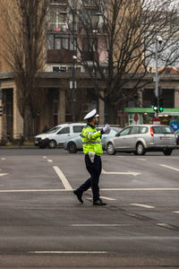 Full length of man standing on street in city