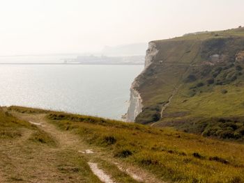 Scenic view of sea and mountains against sky