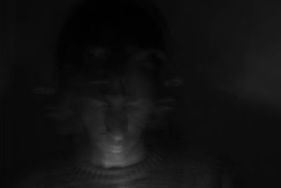 Close-up of human hand against black background