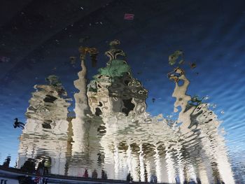 Reflection of building on water in city