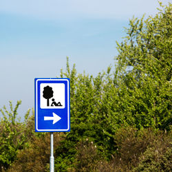 Warning sign against blue sky