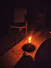 Close-up of lit candles in dark room