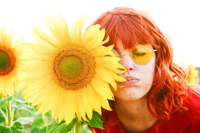 Close-up of woman with sunflower