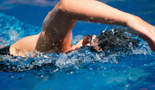 High angle view of mid adult woman swimming in pool