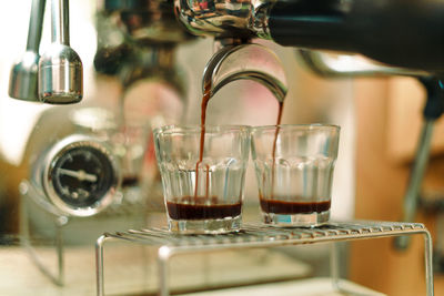 Close-up of wine pouring coffee in glass